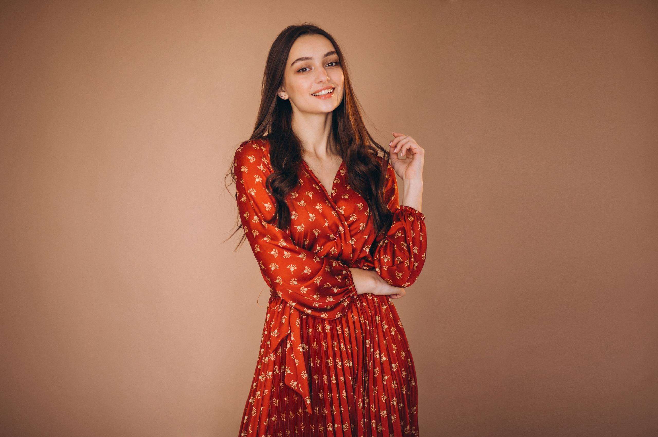 Young woman in a beautiful red dress in studio